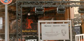 a stage set up for a festival with a sign in front of it