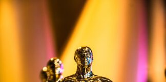 a number of oscar statues on a table