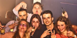 Group of friends posing for a picture at a party.