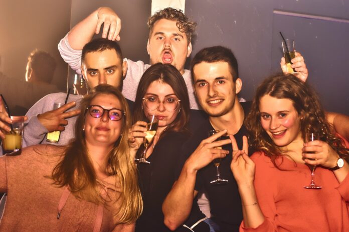 Group of friends posing for a picture at a party.