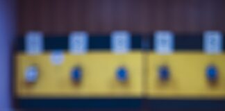 Rifle resting on a wooden table in a shooting range.