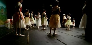 a group of children standing on a stage
