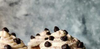 brown and white cupcake with white icing on white ceramic plate