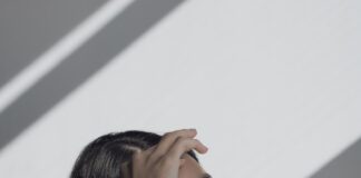 woman leaning on white table