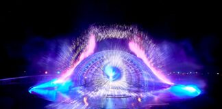 a crowd of people standing around a stage