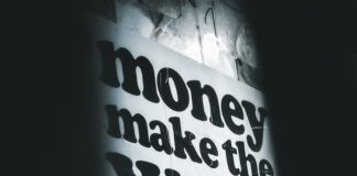 a sign that says money make the world go around