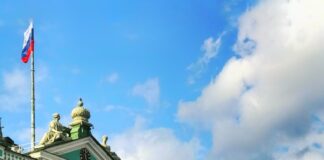 horse with carriage running beside building