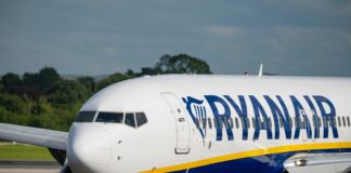A large passenger jet sitting on top of an airport runway
