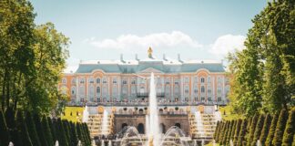 water fountain in front of white concrete building during daytime