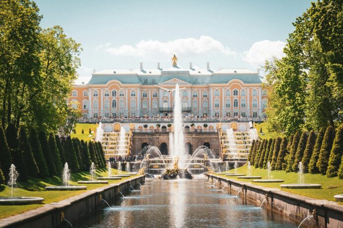 water fountain in front of white concrete building during daytime