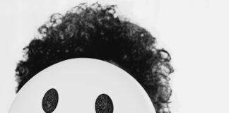 person holding white round ornament