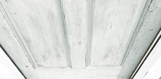 a person's feet on a wooden surface with a sign