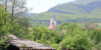 an old brick building with a steeple in the background