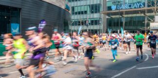 Runners participate in a marathon on a city street.
