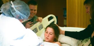 woman lying on hospital bed