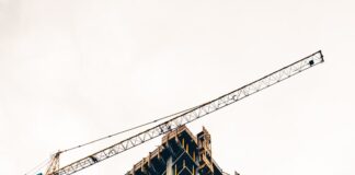 black and white building with yellow crane