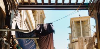 a narrow street with a few shops on both sides