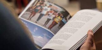 person in blue denim top reading book