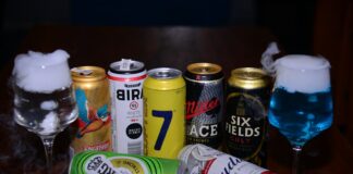a table topped with lots of different types of drinks