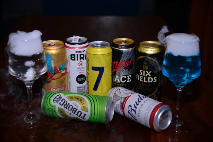 a table topped with lots of different types of drinks