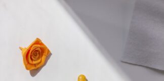 A bottle of pills and a rose on a table