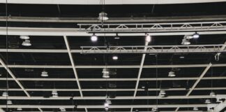 People browse art in a busy, modern gallery.