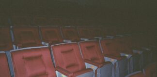 A row of red and gray seats in a stadium