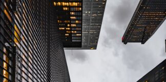 low angle photo of black high rise concrete city buildings