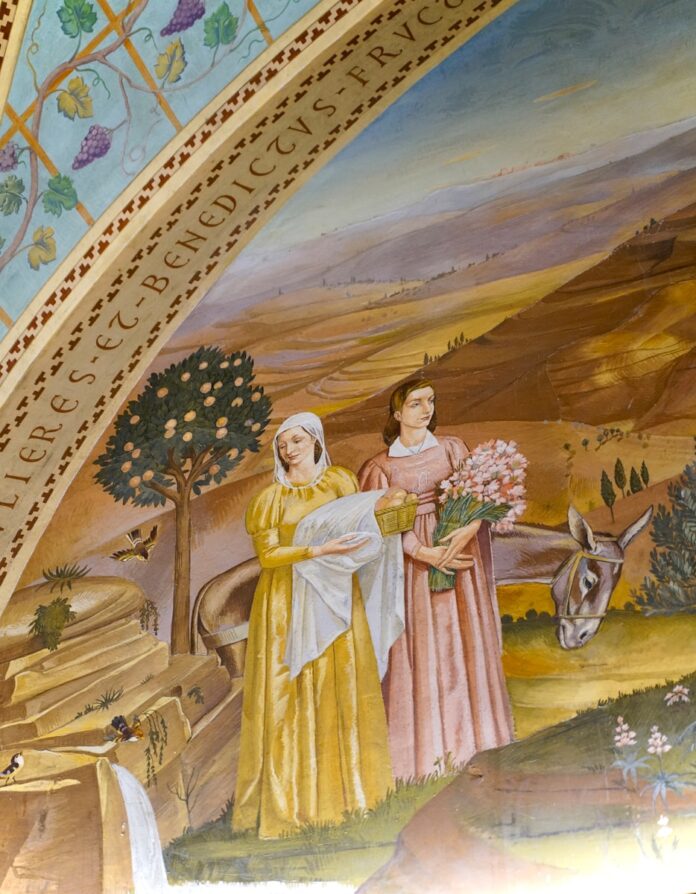 Two women with a baby and flowers