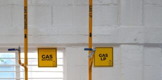 a room with pipes and a sign on the wall