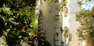 a couple of people walking down a sidewalk