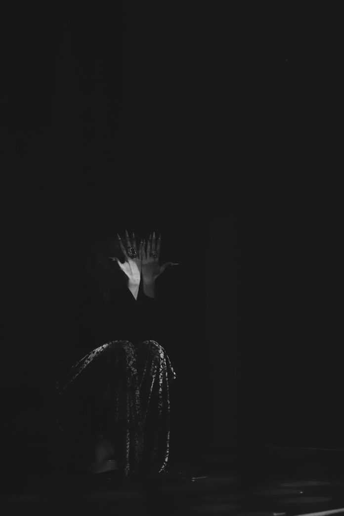 a black and white photo of a flower in the dark