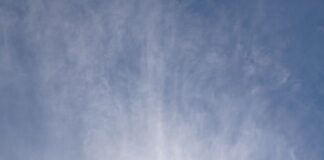 a frisbee flying through the air with a blue sky in the background