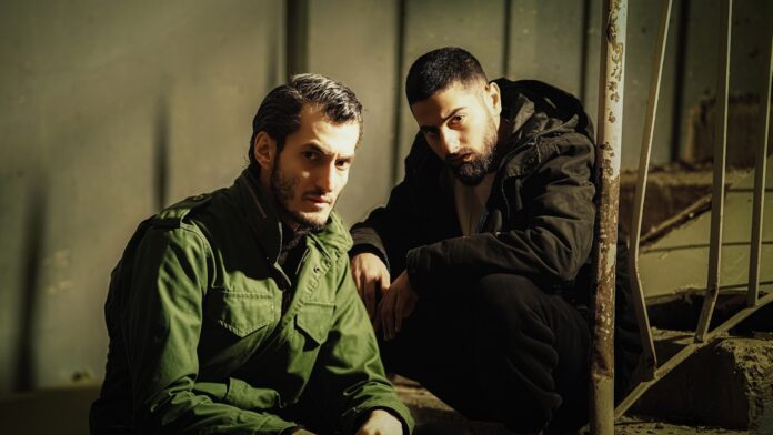 a couple of men sitting next to each other