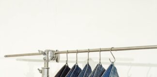 five pairs of jeans hanging on a clothes rack