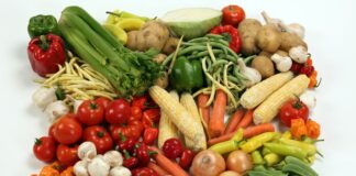 a pile of different types of vegetables on a white surface