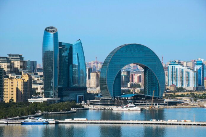 a large body of water with a city in the background