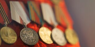 Row of vintage medals with red ribbons