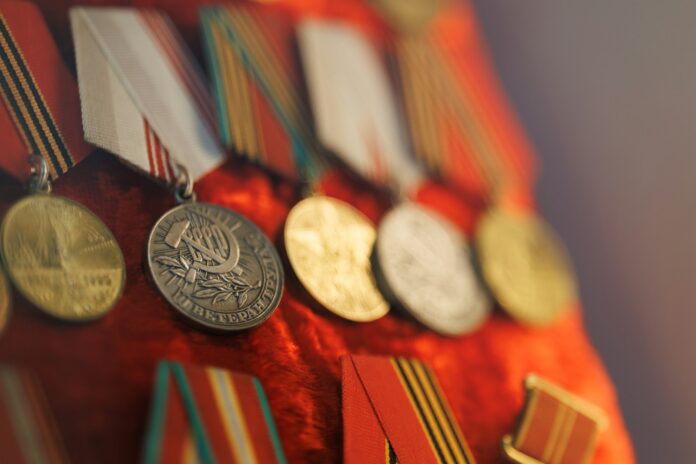 Row of vintage medals with red ribbons