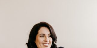 woman in black long sleeve shirt sitting on white couch