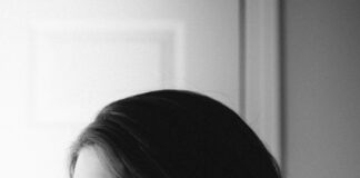 woman in black shirt with white earbuds