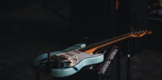 teal and brown electric guitar
