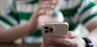 a close up of a person holding a cell phone
