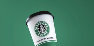 a starbucks coffee cup flying through the air