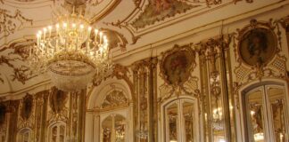 lighted chandelier inside white and brown building