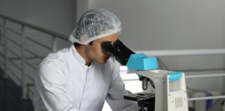 man sight on white microscope