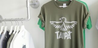 a t - shirt hanging on a rack next to clothes