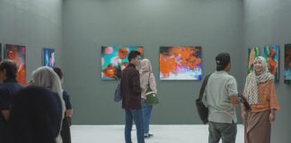 group of people inside museum painting