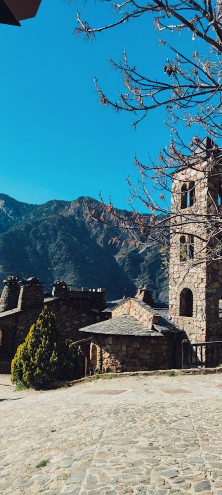 a stone building with a clock on the front of it