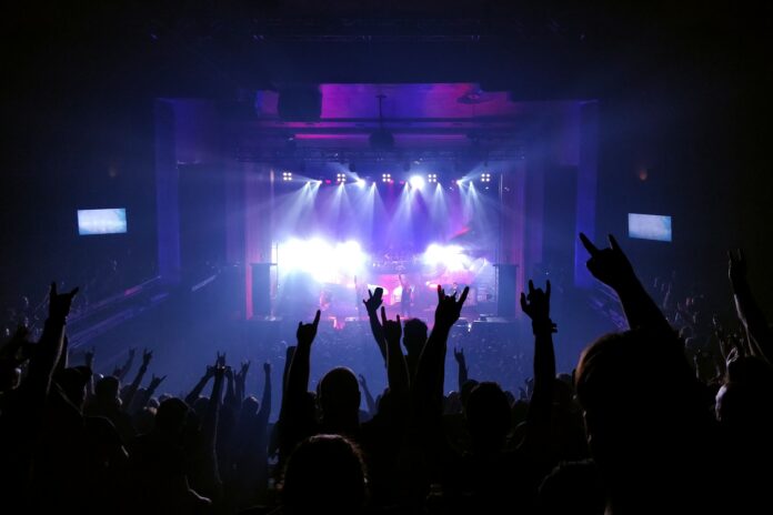 people standing on stage with lights